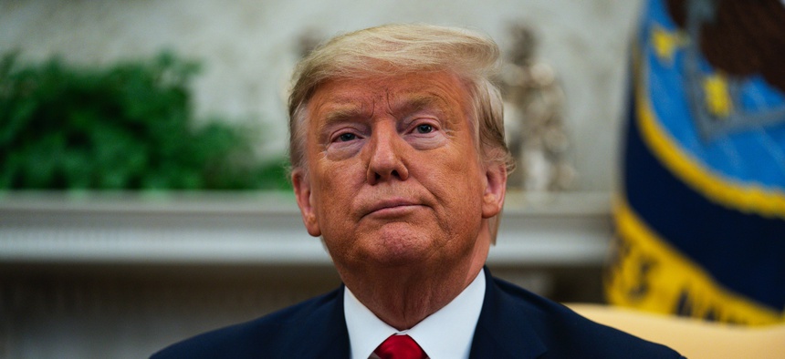 President Donald Trump listens to a question during a meeting with Ecuadorian President Lenin Moreno in the Oval Office of the White House, Wednesday, Feb. 12, 2020, in Washington.