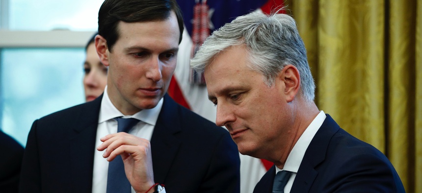 National security adviser Robert O'Brien listens to Trump's senior adviser Jared Kushner in the East Room of the White House, Wednesday, Nov. 13, 2019, in Washington.