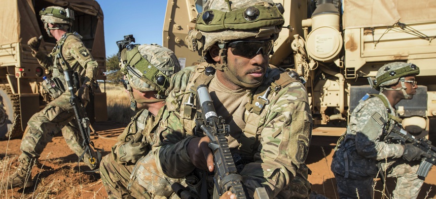 Army Pfc. Cameron Livingston, center, provides security as soldiers move a disabled vehicle as part of an attack scenario during the Shared Accord exercise at the South African Army Combat Training Center in Lohatla, South Africa, July 27, 2017.