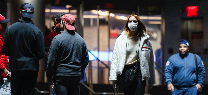 A commuter wears a face mask in the New York City transit system, Monday, March 9, 2020, in New York. New York continued grappling Monday with the new coronavirus, as case numbers, school closings and other consequences grew.