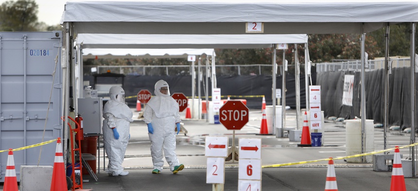 Medical University of South Carolina healthcare providers dress in protective suiting as they get ready to see patients by the hospital's drive-through tent for COVID-19 Testing on March, 13, 2020.l