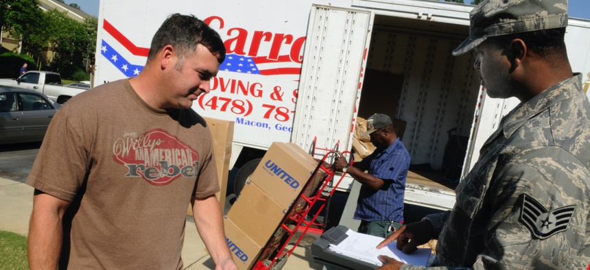 TSgt. Chris Altham, 339th Flight Test Squadron aircrew flight equipment, confers with SSgt. Clarence Lee, 78th Logistic Readiness Squadron quality control inspector about the moving of his household goods.