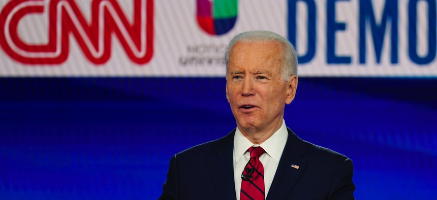 In this Sunday, March 15, 2020, photo, former Vice President Joe Biden, with Sen. Bernie Sanders, I-Vt., speaks during a Democratic presidential primary debate at CNN Studios in Washington.