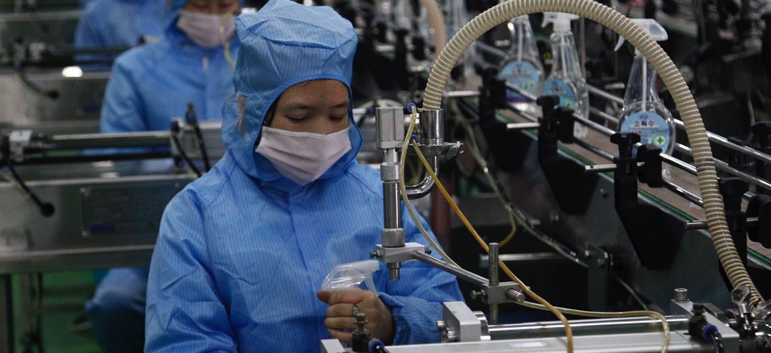 Workers of the Ryongaksan Soap Factory make disinfectant in Pyongyang, North Korea Thursday, March 19, 2020.