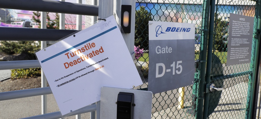 A sign warns of a deactivated employee turnstile at Boeing Co.'s manufacturing facility, Wednesday, March 25, 2020, in Renton, Wash., on the first day of a shutdown due to the spread of the new coronavirus.