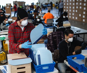 Workers wearing personal protective equipment builds splash guards during a mass manufacturing operation to supply New York City government with protection to distribute against COVID-19, Friday, March 27, 2020, at the Brooklyn Navy Yard in New York. Workers wearing personal protective equipment builds splash guards during a mass manufacturing operation to supply New York City government with protection to distribute against COVID-19, Friday, March 27, 2020, at the Brooklyn Navy Yard in New York.