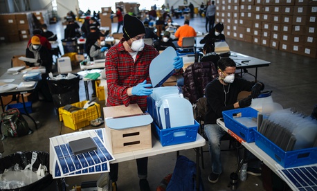 Workers wearing personal protective equipment builds splash guards during a mass manufacturing operation to supply New York City government with protection to distribute against COVID-19, Friday, March 27, 2020, at the Brooklyn Navy Yard in New York. Workers wearing personal protective equipment builds splash guards during a mass manufacturing operation to supply New York City government with protection to distribute against COVID-19, Friday, March 27, 2020, at the Brooklyn Navy Yard in New York.
