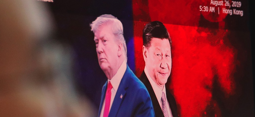 2019 photo of a computer screen in a South Korean trading floor bearing images of Chinese President Xi Jinping, right, and U.S. President Donald Trump