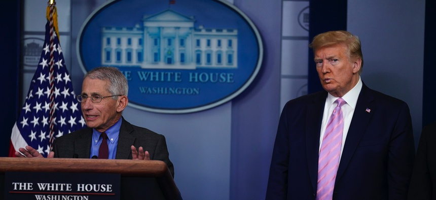 President Donald Trump listens as Director of the National Institute of Allergy and Infectious Diseases Dr. Anthony Fauci speaks during a coronavirus task force briefing at the White House, Friday, April 10, 2020, in Washington.
