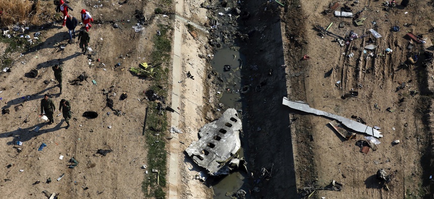 In this Wednesday, Jan. 8, 2020 file photo, rescue workers search the scene where a Ukrainian plane crashed in Shahedshahr, southwest of the capital Tehran, Iran.