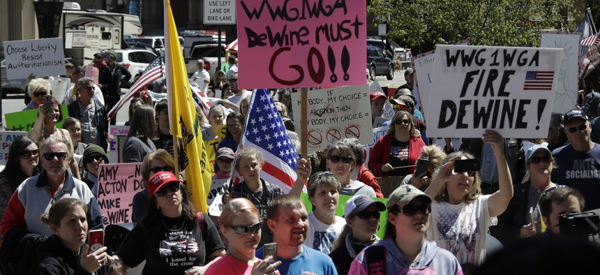 Protesters gather outside of the Ohio State House in Columbus, Ohio on April 20, 2020, to protest the stay home order that is in effect until May 1.