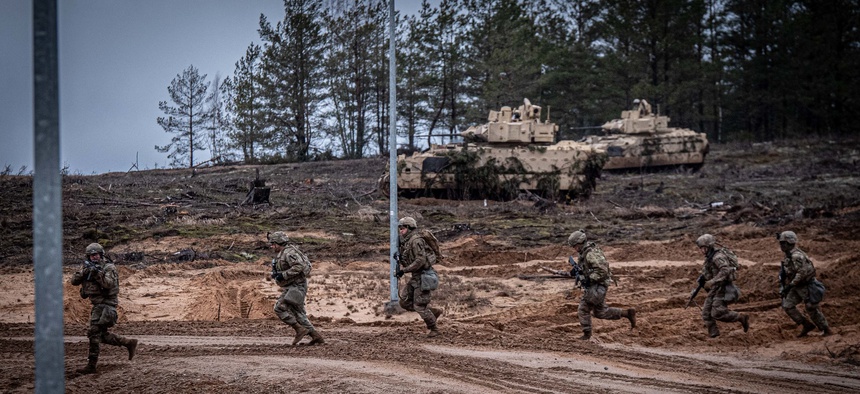 Soldiers from the U.S. Army’s 1st Cavalry Division charge across a road during a live-fire exercise at Pabradė Training Grounds in Lithuania, Feb. 12, 2020. More than 500 were deployed in 2019 to reinforce NATO's presence there.