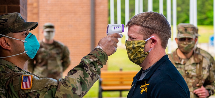 FORT BENNING, Ga. - Secretary of the Army Ryan McCarthy has his temperature taken at 30th Adjutant Battalion (Reception) during his visit to the Maneuver Center of Excellence April 29.