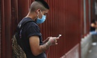 A man wearing a mask against the spread of the new coronavirus chats on his mobile phone outside a hospital in Iztapalapa in Mexico City, Thursday, April 30, 2020 A man wearing a mask against the spread of the new coronavirus chats on his mobile phone outside a hospital in Iztapalapa in Mexico City, Thursday, April 30, 2020