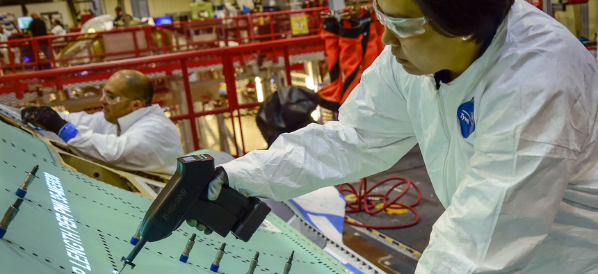 A Northrop Grumman technician assembles the fuselage of an F-35 Joint Strike Fighter.
