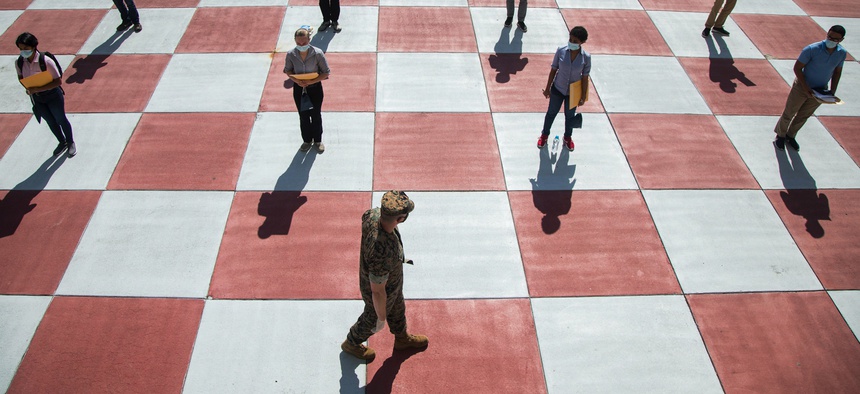 Marine Corps poolees await medical screening at The Citadel, a public military college in Charleston, S.C., where poolees are undergoing a 14-day observation period amid the coronavirus pandemic, May 4, 2020.