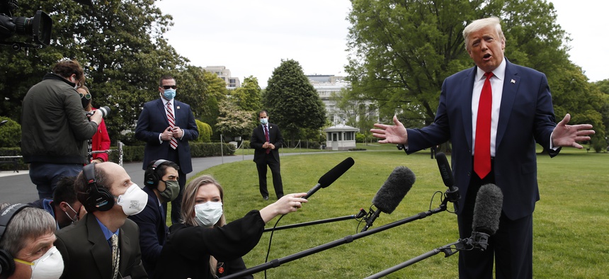 President Donald Trump speaks with reporters on the South Lawn of the White House as he departs on Marine One, Thursday, May 14, 2020, in Washington.