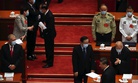 Hong Kong Chief Executive Carrie Lam, upper left, talks with a fellow delegate as Chinese President Xi Jinping, lower right, leaves after the opening session of China's National People's Congress in Beijing, Friday, May 22, 2020.