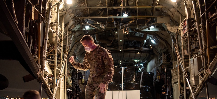 U.S. Air Force Brigadier General Richard R. Neely, the Adjutant General of the State of Illinois, briefly meets with the crew on a C-130H Hercules aircraft assigned to the 182nd Airlift Wing, Illinois Air National Guard.