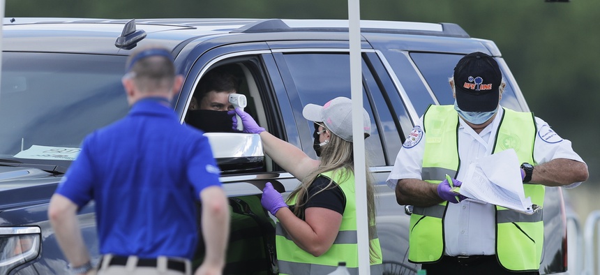 Driver Erik Jones gets his temperature taken as he arrives at Darlington Raceway before the Real Heroes 400 NASCAR Cup Series auto race Sunday, May 17, 2020, in Darlington, S.C.