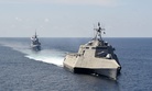 The Independence-variant littoral combat ship USS Gabrielle Giffords (LCS 10), front, exercises with the Republic of Singapore navy Formidable-class multi-role stealth frigate RSS Steadfast (FFS 70) in the South China Sea, May 25, 2020.