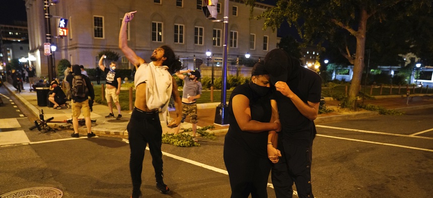 EDS NOTE: GRAPHIC CONTENT - A helicopter circles low as demonstrators gather to protest the death of George Floyd, Monday, June 1, 2020, near the White House in Washington. Floyd died after being restrained by Minneapolis police officers.