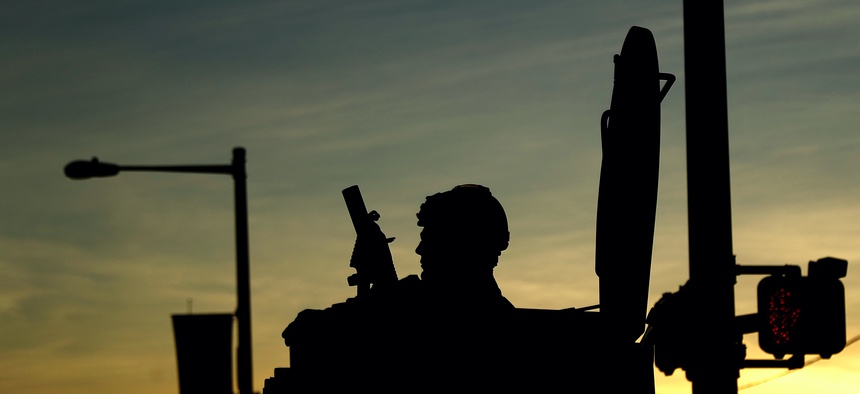 A Philadelphia Police Department SWAT team member sits in a vehicle in downtown Philadelphia during enforcement of a curfew, Monday, June 1, 2020.