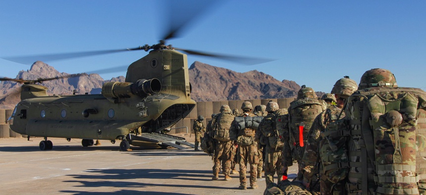 Iowa National Guard and 10th Mountain Division troops load onto a Chinook helicopter to head out and execute missions across the Combined Joint Operations Area-Afghanistan in January 2019.