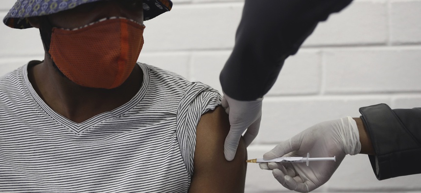 A vaccine volunteer gets an injection at the Chris Hani Baragwanath hospital in Soweto, Johannesburg Wednesday, June 24, 2020.