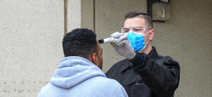 Airman 1st Class Kyle Larson, a medical technicial with 75th Medical Group, screens an incoming patient before entering the Hill Air Force Base, Utah medical clinic March 31, 2020.