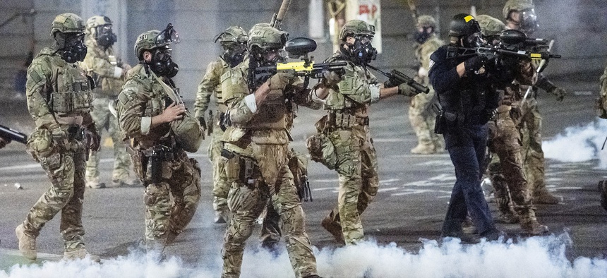 Federal agents use crowd control munitions to disperse Black Lives Matter protesters at the Mark O. Hatfield United States Courthouse on Monday, July 20, 2020, in Portland, Ore.