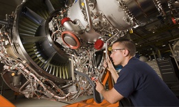 A Pratt & Whitney employee works on an engine in Middletown, Connecticut.