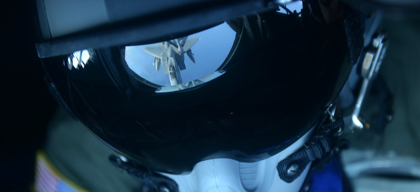 Senior Airman Charlton Hampton refuels an F-15C Eagle from a KC-135 Stratotanker Dec. 23, 2014, near Okinawa, Japan, Dec. 23, 2014.