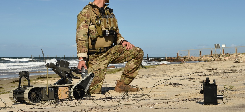 An explosive ordnance disposal technician prepares a remote-controlled robotic for a mission during Exercise Northern Coasts in Putlos, Germany, Sept. 13, 2019.