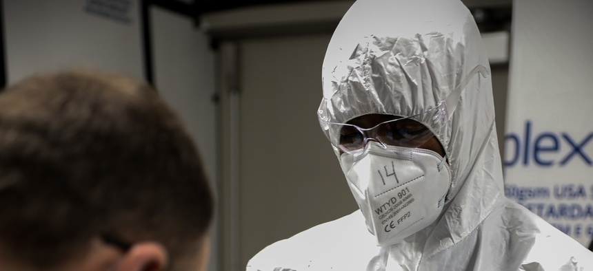 A medical professional, does a thorough check-over of the TCF Center cleaner and maintainer, at the Detroit, Mich. TCF center, April 15th, 2020.