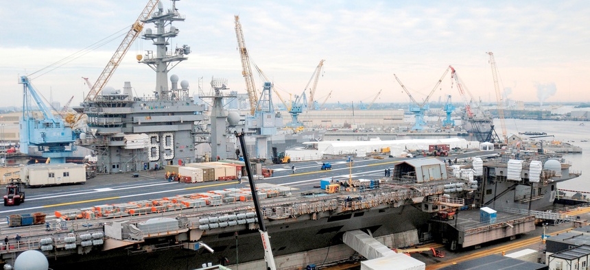 The aircraft carrier USS Dwight D. Eisenhower (CVN 69) sits in dry dock during a 14-month scheduled docking planned incremental availability at Norfolk Naval Shipyard.