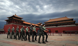Chinese People's Liberation Army soldiers march past the closed Forbidden City in Beijing on May 25, 2020.