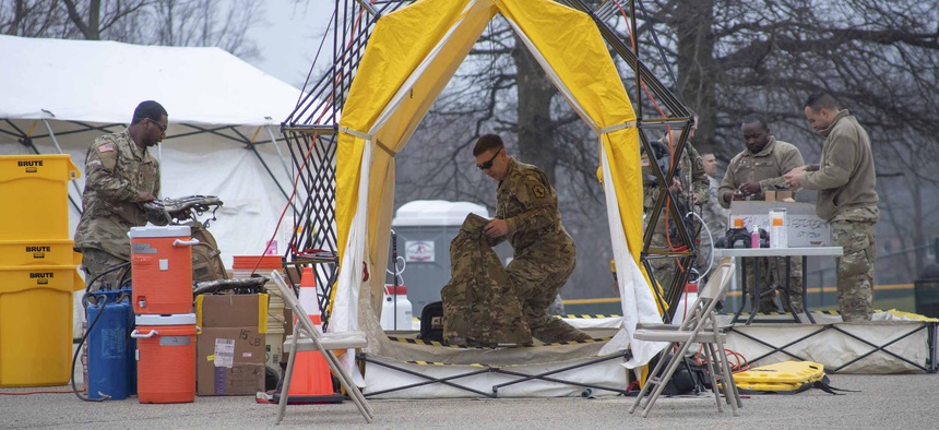 Pennsylvania Air National Guardsmen set up gear at a mass coronavirus test center in Upper Dublin Township, Pa., March 20, 2020.