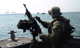 A U.S. sailor assigned to Coastal Riverine Squadron 10 provided seaward security for a vessel at the Port of Djibouti in 2015.