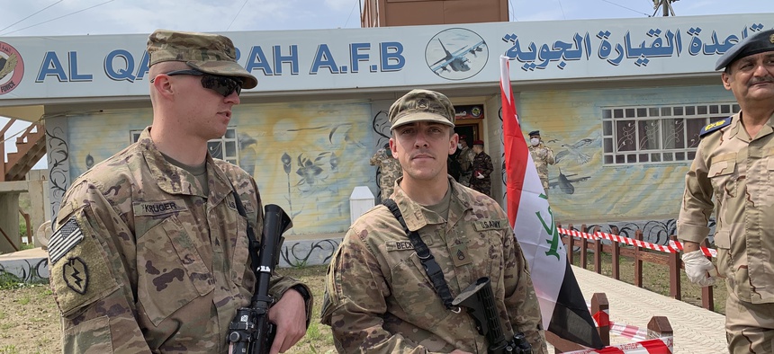 U.S. soldiers stand guard during the hand over ceremony of Qayyarah Airfield, Iraqi Security Forces, in the south of Mosul, Iraq early Friday, March 27, 2020.