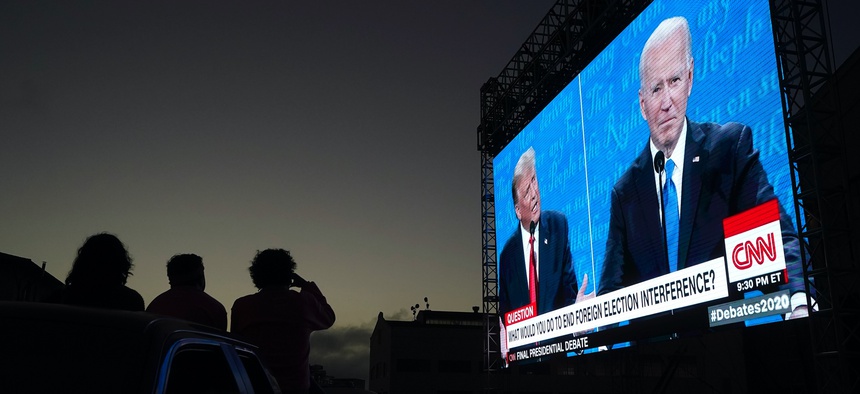 President Donald Trump and former Vice President Joe Biden speak as people watch at Fort Mason Center in San Francisco on Oct. 22, 2020.