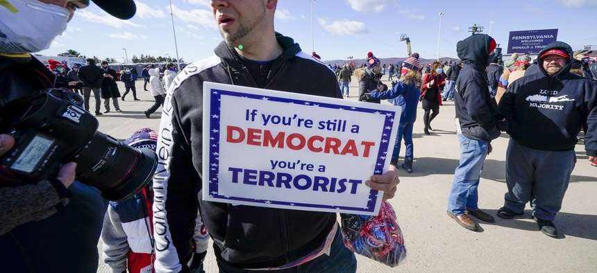 Robert Bovolick, of Kingston, Pa, center, awaits the arrival of President Donald Trump at a campaign rally at the Wilkes-Barre Scranton International Airport in Avoca, Pa, Monday, Nov. 2, 2020.