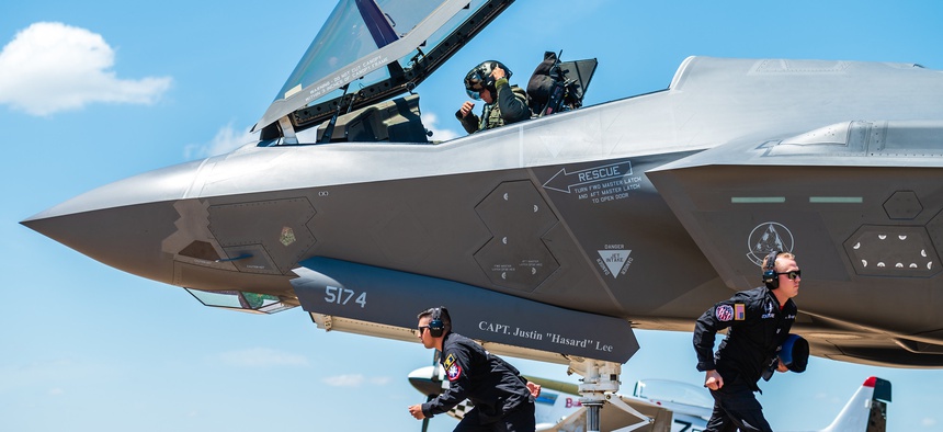 F-35 Lightning II demonstration team members sprint to their positions during the ground show at the Defenders of Liberty Air & Space Show at Barksdale Air Force Base, La.