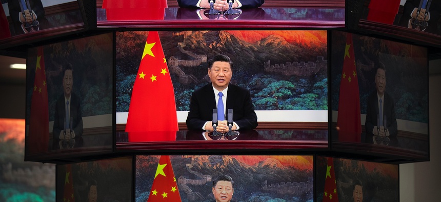 Video screens show Chinese President Xi Jinping as he delivers an address to the opening ceremony of the China International Import Expo in Shanghai, Wednesday, Nov. 4, 2020.