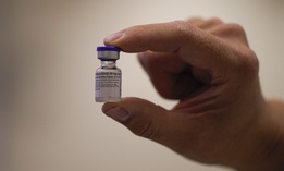 David Cheng, director of inpatient pharmacy, holds the Pfizer-BioNTech COVID-19 vaccine at Kaiser Permanente Los Angeles Medical Center in Los Angeles, Monday, Dec. 14, 2020
