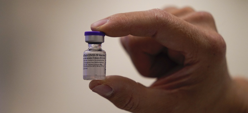 David Cheng, director of inpatient pharmacy, holds the Pfizer-BioNTech COVID-19 vaccine at Kaiser Permanente Los Angeles Medical Center in Los Angeles, Monday, Dec. 14, 2020
