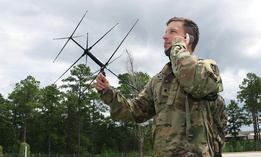 A student in the Special Forces Communications Sergeant course uses an AV-2125 satellite antenna with an AN/PRC-117G satellite radio during training. 