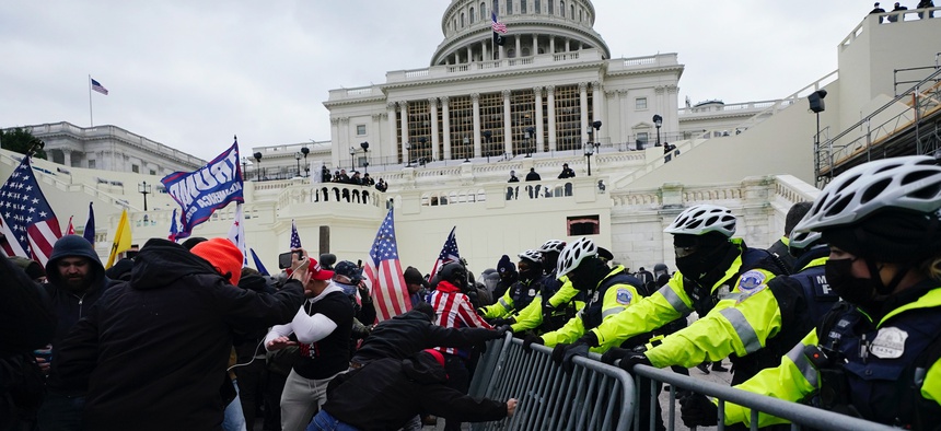 Trump supporters try to break through a police barrier, Wednesday, Jan. 6, 2021, at the Capitol in Washington.
