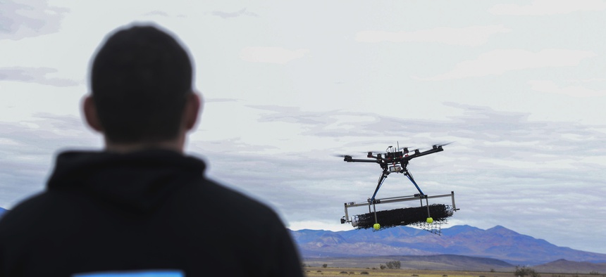 U.S. Air Force 2nd Lt. David Feibus flies one of his team's DJI S1000 drone during the setup and calibration phase of the AFRL Commander's Challenge near Las Vegas in 2016.