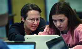 A teacher librarian at Brookfield, Conn., High School works with a freshman in her Digital Student class, a required course in which students learn to evaluate online information.